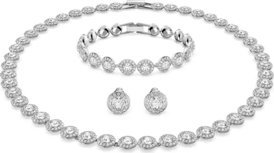 A jewelry set including a necklace, bracelet, and earrings, all made of silver-toned metal and adorned with clear crystals.