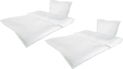 Two sets of white bedding are displayed diagonally on a white background.