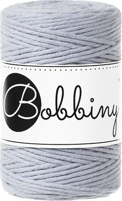A spool of macrame cord on a white background.