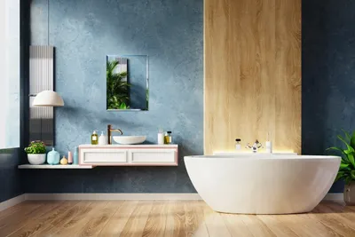 A modern bathroom with a freestanding bathtub, vanity, and mirror.