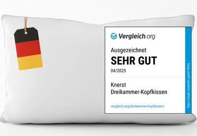 A white pillow with a German flag tag and a "Vergleich.org" award badge.