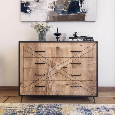 A dresser with a decorative pattern on the drawers, placed in a room with a painting above it and a rug in front.