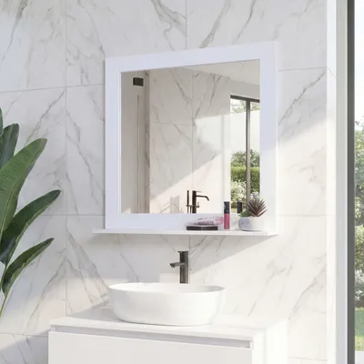 A bathroom scene with a mirror, sink, and faucet.