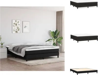 A bedroom scene with a black boxspring bed, a nightstand, and artwork on the wall.