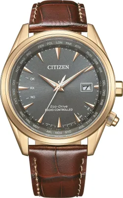 A close-up studio shot of a men's wristwatch with a brown leather strap and a gold-toned case.
