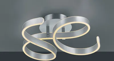 A modern, silver-colored ceiling light with swirling, ribbon-like arms illuminated by integrated LED lights.