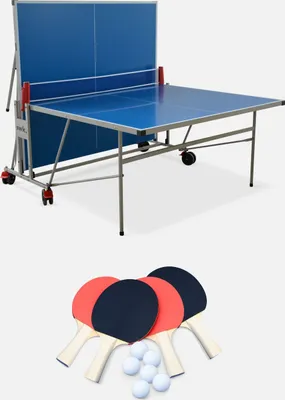 A blue outdoor table tennis table is shown folded up, with four paddles and six balls arranged in front of it.