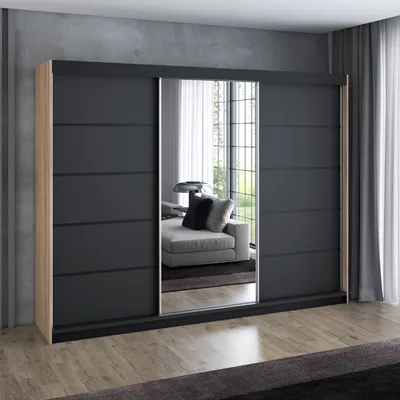 A modern sliding door wardrobe with a mirrored center panel, set in a bedroom with a concrete wall and wooden floor.