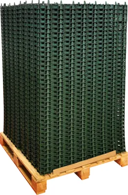 A stack of green plastic grid mats on a wooden pallet.