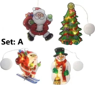 A set of four illuminated Christmas-themed window decorations.