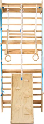 A wooden indoor climbing frame with various attachments.