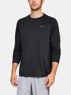 A man wearing a black long-sleeved shirt and grey shorts.