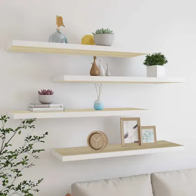 Four white and wood-colored shelves mounted on a white wall, decorated with various items.