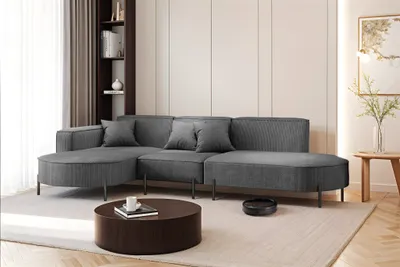 A modern living room with a grey sectional sofa, coffee table, and artwork.