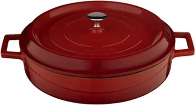 A red enameled cast iron pot with a lid and handles, shown from a slightly elevated side angle against a white background.