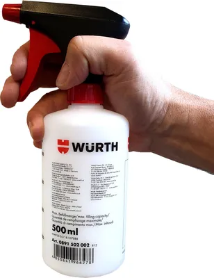 A hand holding a WURTH spray bottle.