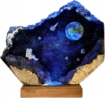 A diorama of a space scene inside a geode-like structure, illuminated from within.