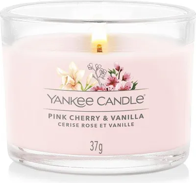 A lit Yankee Candle in a glass jar with a label.
