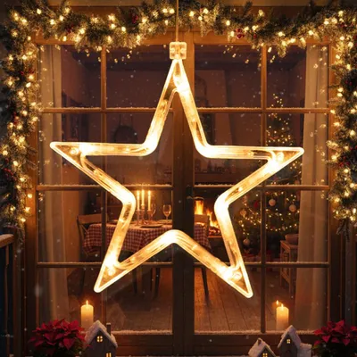 A festive Christmas window decoration featuring a large illuminated star.
