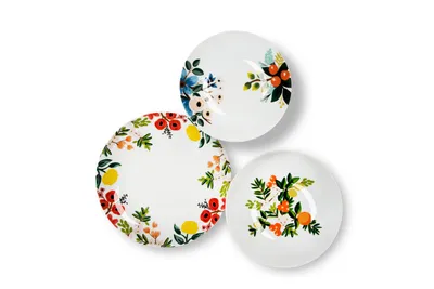 Three decorative plates with floral and fruit patterns are arranged on a white background.