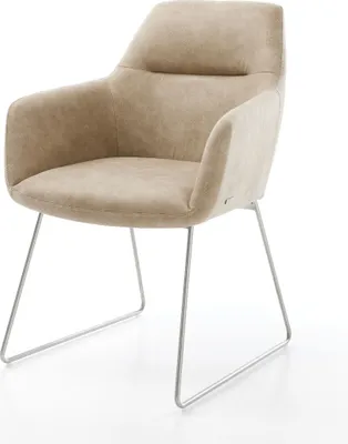 A single beige armchair with a metal frame on a white background.