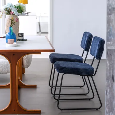 A dining table with two chairs in a room.