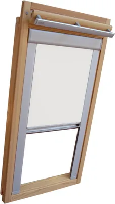 A close-up view of a wooden-framed skylight window with a white roller blind partially lowered.