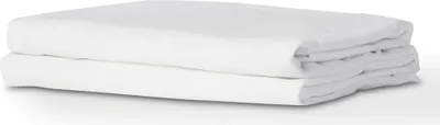 A folded white mattress protector is shown on a white background.