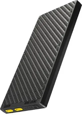 A black and gray power bank with a carbon fiber texture is shown against a white background.