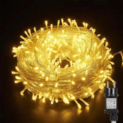 A coiled string of warm white LED lights with a black power adapter.