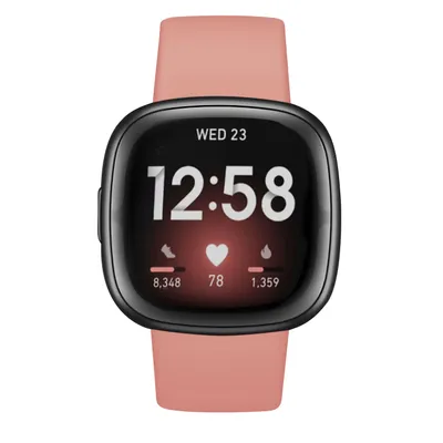 A Fitbit Versa 4 smartwatch with a pink band is shown against a white background.