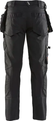 The back view of a pair of black work pants with multiple pockets.