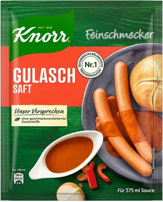 A Knorr Feinschmecker Gulasch Saft packet with sausages and a roll on a plate.