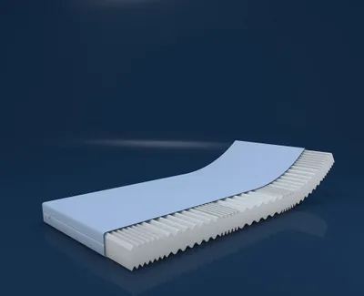 A 3D rendering of a mattress cross-section showing its layered structure, with a blue top layer and a white, wavy foam base.