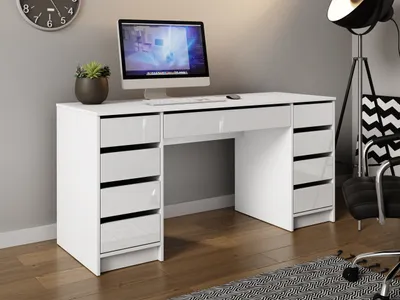 A white desk with a computer and a plant on it, set against a light gray wall.