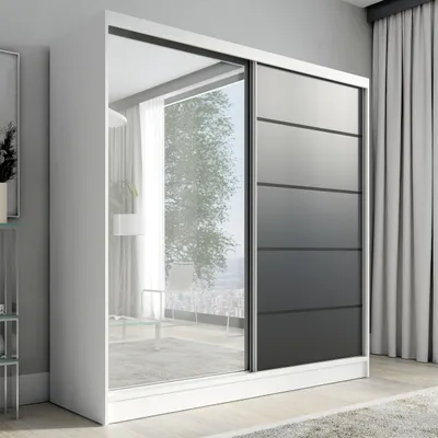 A modern white wardrobe with mirrored doors and black panel accents, set in a well-lit room with sheer curtains in the background.