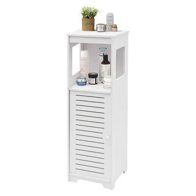 A white floor cabinet with a slatted door and an open shelf, displaying various toiletries and a small potted plant on top.
