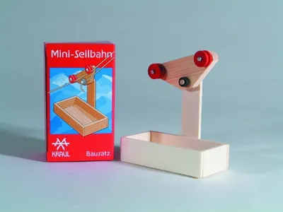A wooden toy cable car kit and its packaging are displayed against a light gray background.