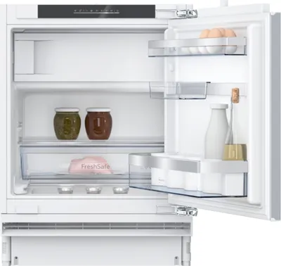 The interior of a white refrigerator with the door open, showing shelves, drawers, and various food items.