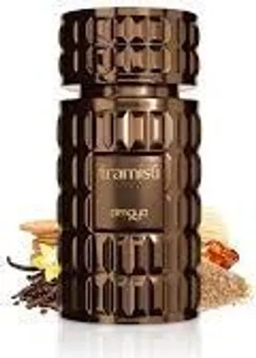 A bottle of perfume with ingredients like vanilla beans and sugar around it.