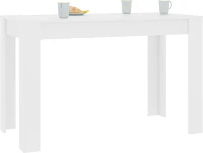 A white dining table with two cups and a pastry on top.