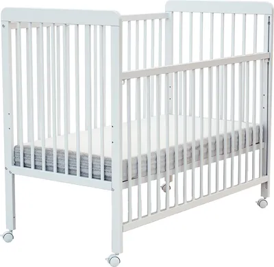 A white wooden baby crib with a mattress on a white background.