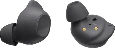 Two dark gray Samsung Galaxy Buds FE headphones are shown against a white background. The left earbud is shown from the side, and the right earbud is shown from the bottom, revealing charging contacts and the 'R' marking.