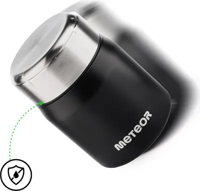 A black insulated food container with a silver lid, shown at an angle against a white background. A green dotted line points to the lid seal, and a small circular icon with a water drop and a diagonal line through it is visible in the lower left corner.