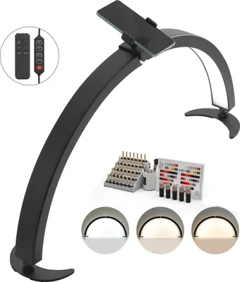 A black desk lamp with a phone holder is shown on a white background, along with some nail polish and tools.