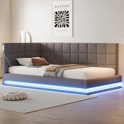 A modern grey upholstered bed with blue LED lighting.