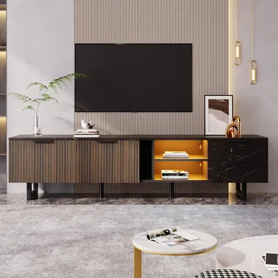 A modern living room with a TV stand and a television mounted on the wall.