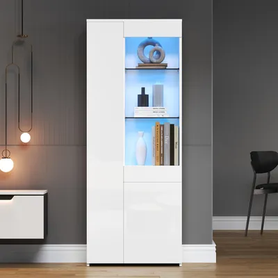A modern white display cabinet with LED lighting, showcasing decorative items and books, in a room with a gray wall and a chair in the background.