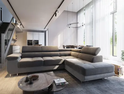 A modern living room with a large sectional sofa, dining area, and staircase.