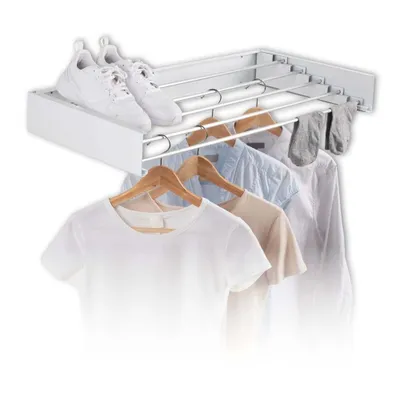 A wall-mounted drying rack with clothes and shoes on it.